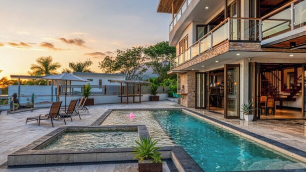 A modern house with a swimming pool, lounge chairs, and a patio area. - Simply Spectacular Luxury Ocean View Villa!  (Uvita)
