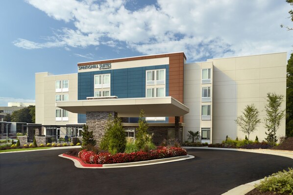 A modern hotel with a stone facade, large windows, and a landscaped entrance. - SpringHill Suites by Marriott Atlanta Northwest (Atlanta)