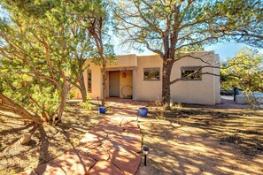 Stroll along the shaded pathway to a serene single-story retreat.