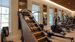 A gym with a rowing machine, stationary bikes, and mirrors. - Pet Friendly in Seaside, Location, Large Wrap-Around Balcony, and Gulf View! (Santa Rosa Beach)