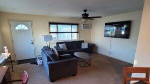 A living room with a sofa, coffee table, and TV. - Great location, 10 min downtown Denver. 15 to Red Rocks. Regis university 5 min  (Mountain View)