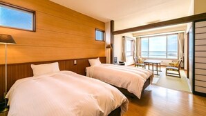 A hotel room with two beds, a wooden wall, a window, and a balcony with a view. - Ocean Front Hamada-kan (Hitachinaka)