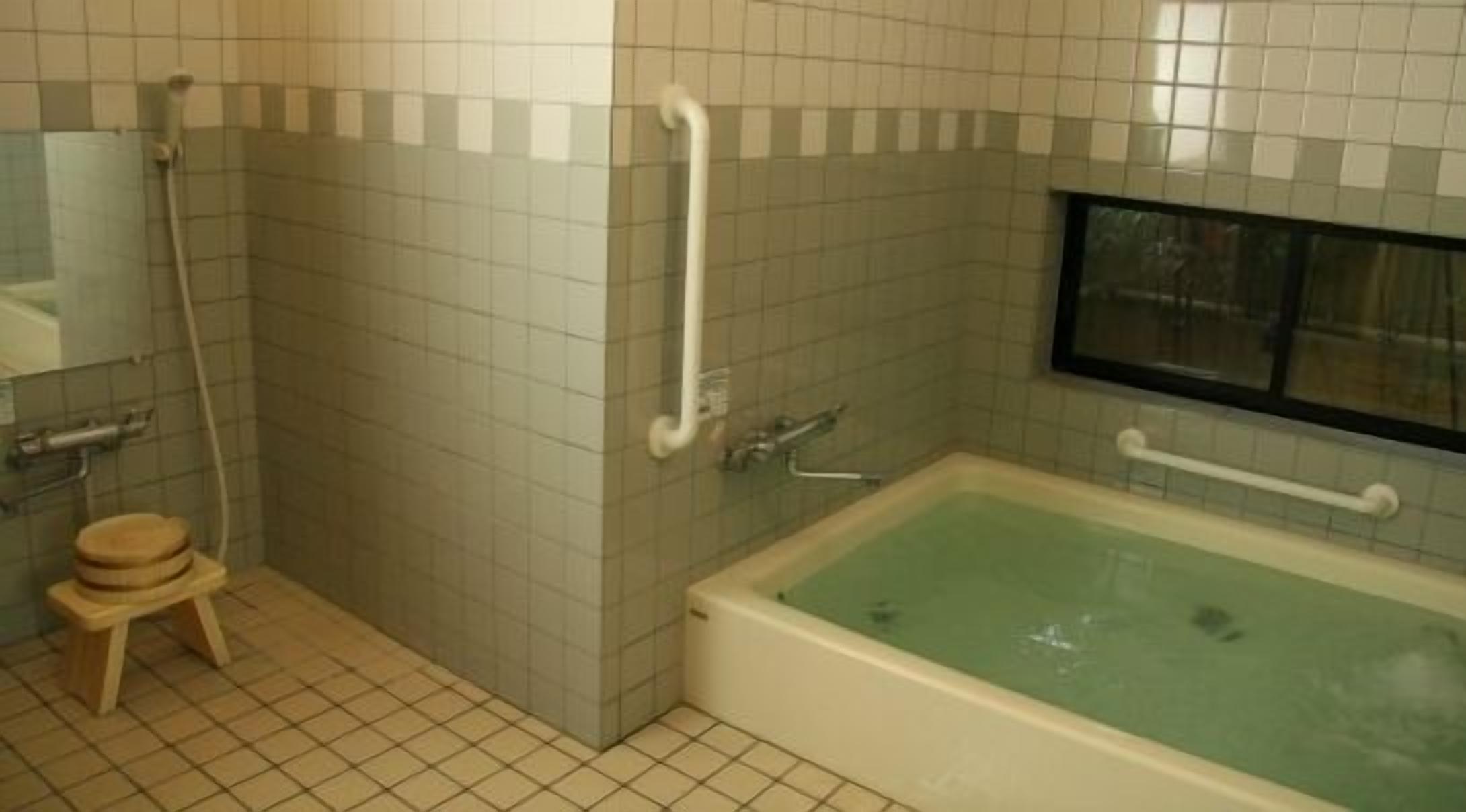 A bathroom with a bathtub, a toilet, a sink, and a shower.