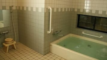 A bathroom with a bathtub, a toilet, a sink, and a shower.