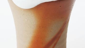 A cylindrical object with a gradient color pattern and a white top.