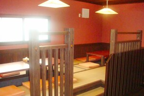 A room with bunk beds, a window, and a wall-mounted light fixture. - Shibetsu Grand Hotel (Shibetsu)