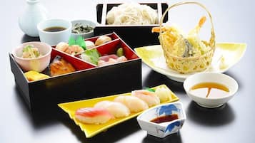 A variety of sushi dishes and condiments arranged on a table.