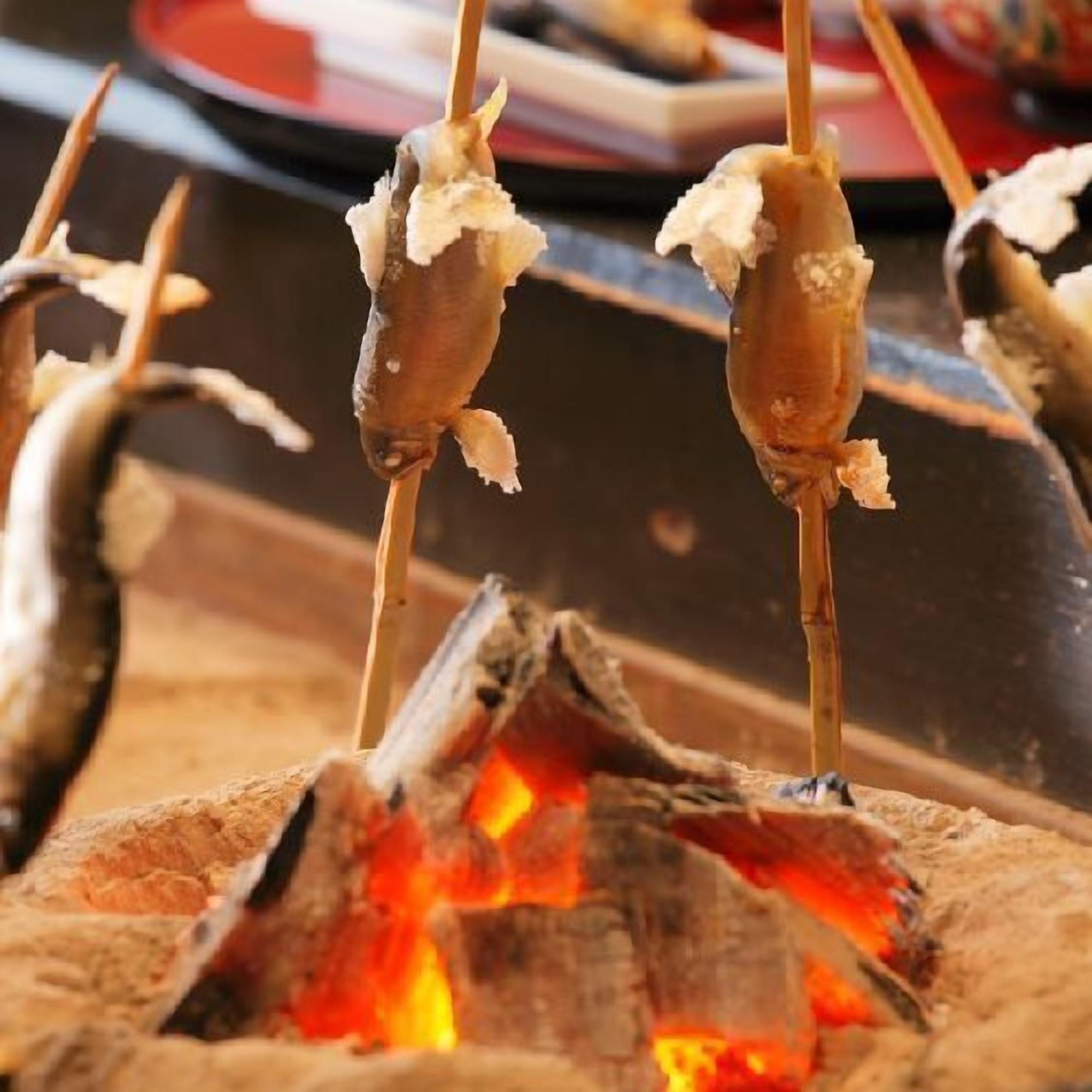 Skewers of food over an open flame.