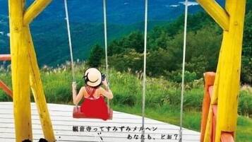 A wooden swing set overlooking a scenic view with a map and text overlay.