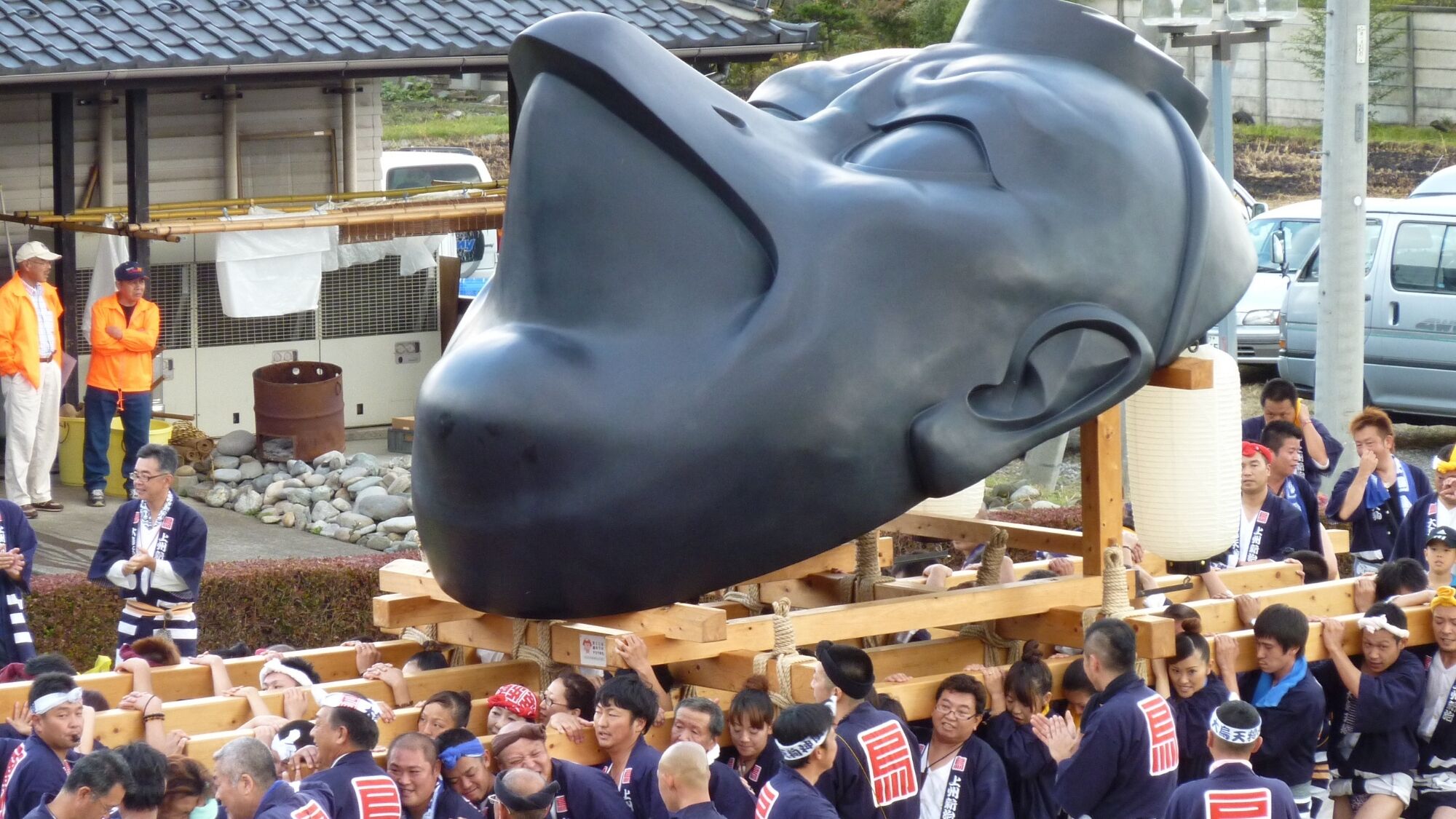 A crowd gathered around a large sculpture.