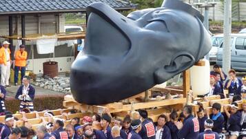 A crowd gathered around a large sculpture.