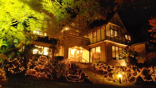 A two-story house with a brick facade and large windows. - Rindou (Shizuoka)