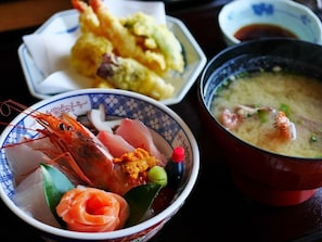 A bowl of sashimi with shrimp and salmon, a bowl of soup with seafood, and a plate of tempura. - J Hotel Tokyo Geo (Tokyo)
