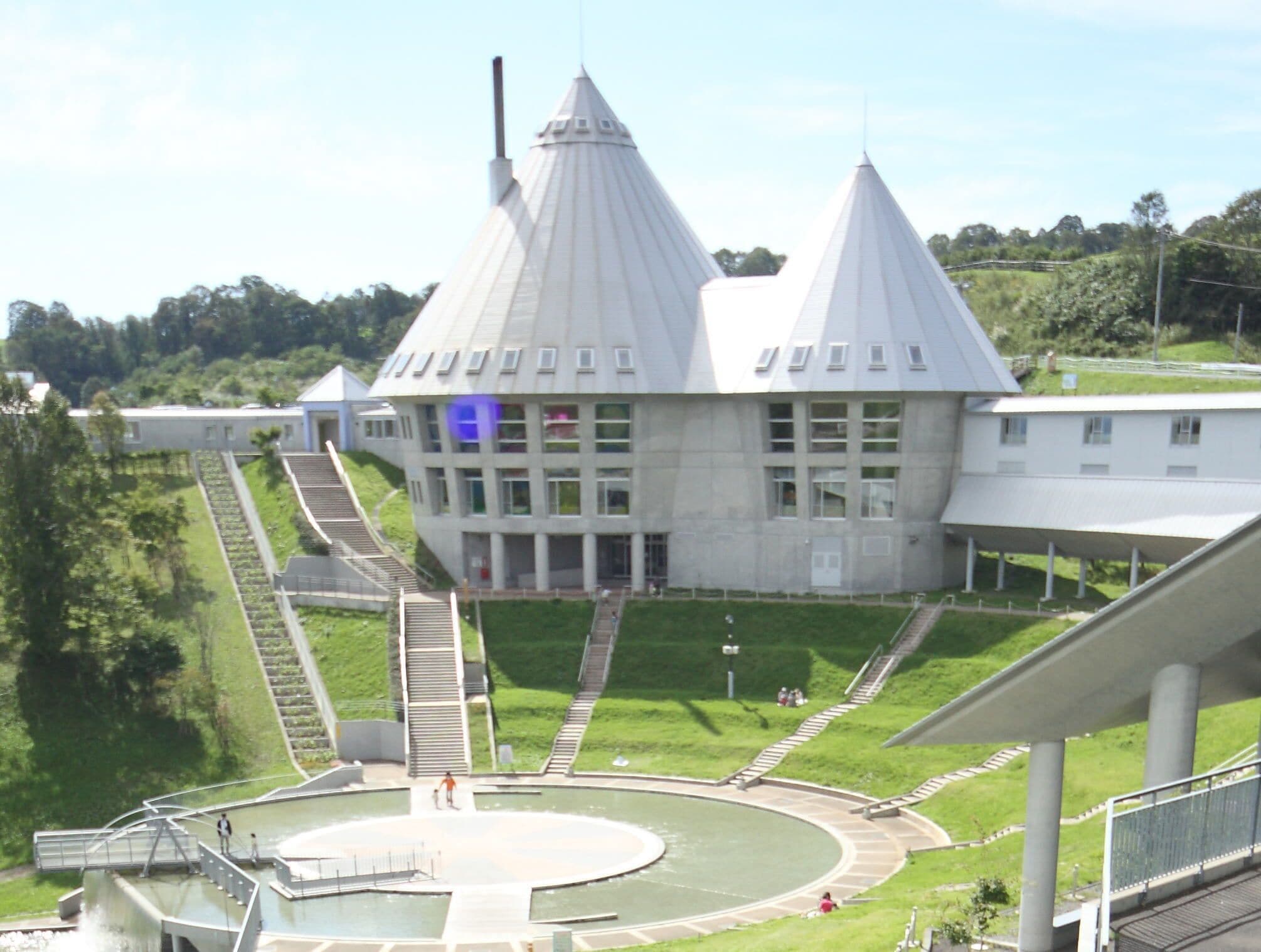 A large building with a central circular courtyard, multiple staircases, and a prominent tower.