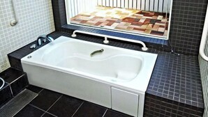 A bathroom with a bathtub, a window with a view of the sea, and a tiled floor. - Epurontei (Miyazaki)