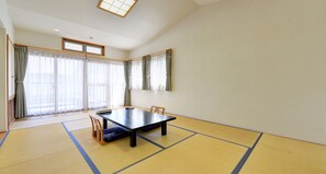 A room with tatami mats, a low table, a chair, and large windows with curtains. - Oishii Gakko (Hokuto)