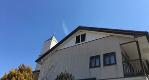 A building with a sloped roof, a chimney, and multiple windows. - Oishii Gakko (Hokuto)