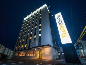 A multi-story hotel with a prominent 'SuperHotel' sign.