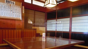 A traditional Japanese room with tatami flooring, a wooden table, and shoji screens. - Sunrise Hotel (Ryugasaki)