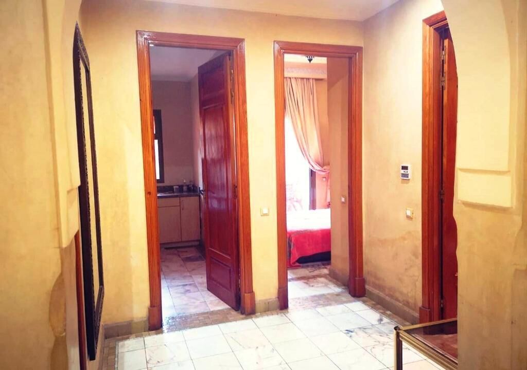 A hallway with wooden doors leading to rooms.