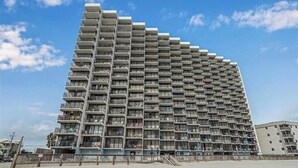 A high-rise building with multiple balconies, likely a hotel or residential complex.