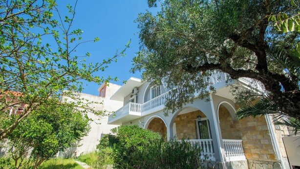 A two-story building with a balcony and arches, surrounded by greenery. - Immaculate 1-Bed House in Zakynthos (Zakynthos)