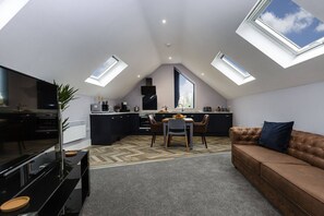 A modern loft apartment with a kitchen, dining area, and living room. - Luxury modern Loft apartment by Bootique (Wakefield)