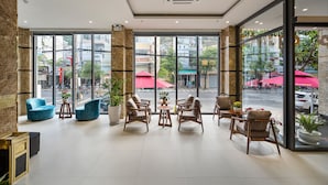 A spacious lobby with large windows, comfortable seating, and a modern design. - Aquatel Vung Tau (Ho Chi Minh City)
