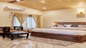 A bedroom with a wooden ceiling, a bed with a wooden frame, a bedside table with a lamp, and a window with curtains. - Hotel Walnut Creek (Nainital)