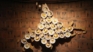 A wall with a brick pattern and a wooden cutout of a map. - Prime (Sapporo)