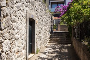 Un estrecho sendero de piedra que conduce a un edificio con una puerta marcada con el número 8.
