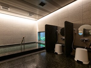 A modern bathroom with a large mirror, a shower area, and a small window. - Fukuoka U-BELL Hotel (Fukuoka)