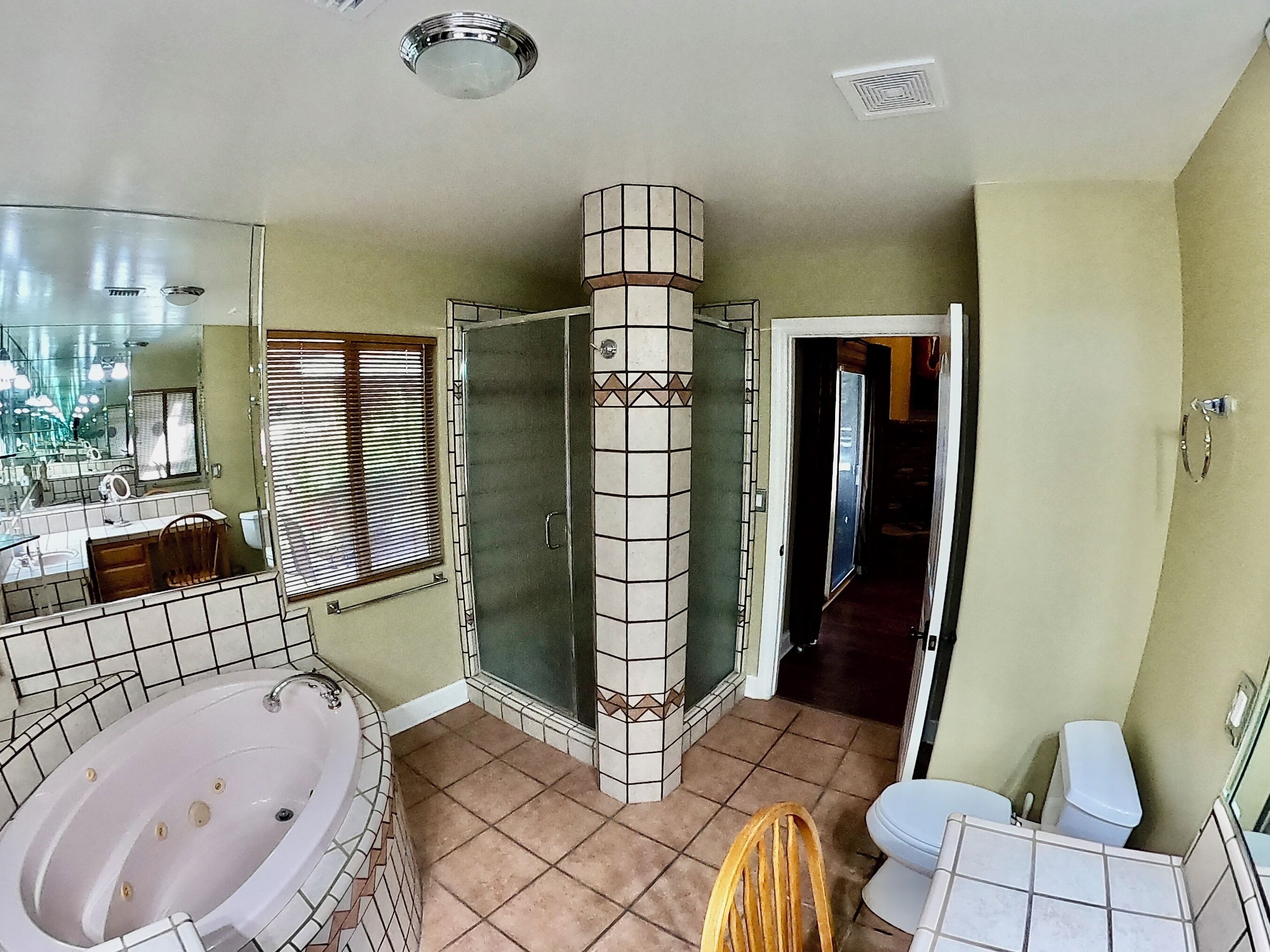 Un baño con bañera, inodoro y zona de ducha.