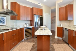 Enjoy cooking in this well-equipped kitchen with a central island, oven, microwave, and refrigerator.