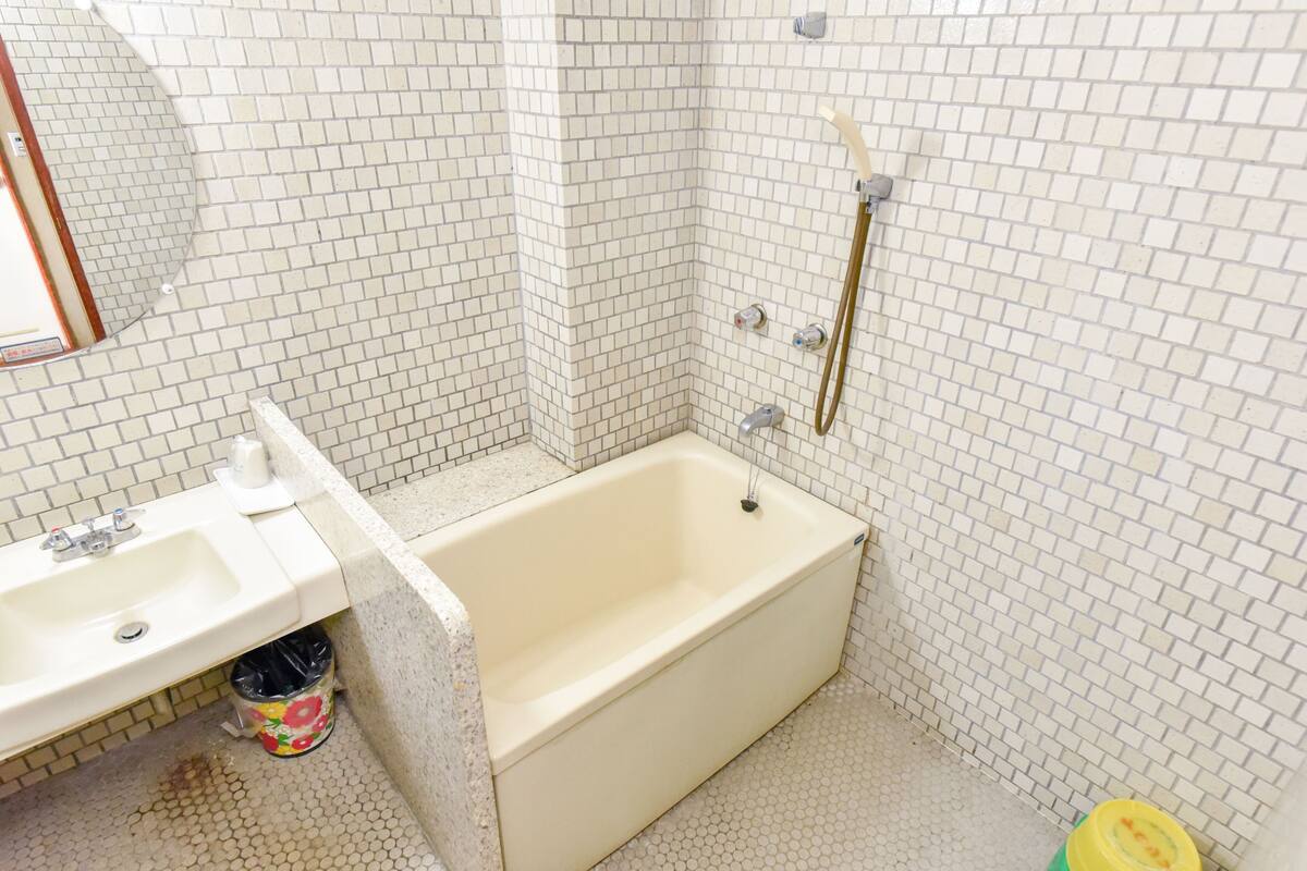 Un baño con bañera, lavamanos e inodoro.
