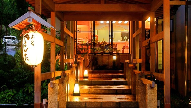 A traditional Japanese building with a wooden staircase leading to a covered entrance. - Yamashita (Kanazawa)