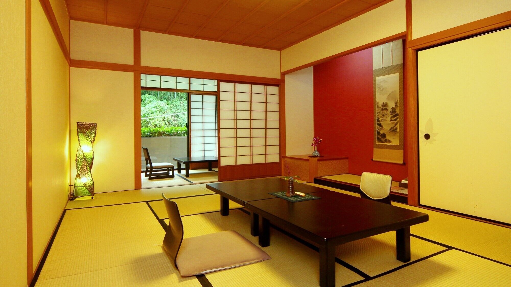 A traditional Japanese room with tatami flooring, a low table, and sliding doors.