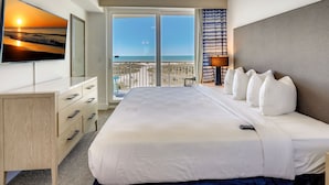A hotel room with a large bed, a desk, and a TV on the wall. - ☀️Oceana 202 West☀️Beachfront☀️Private Balcony☀️Direct Beach Access (Treasure Island)