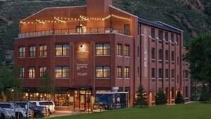 A brick building with a sign reading "Taproom & Hotel The EDDN" and a parked food truck labeled "Shakes." - The Eddy Taproom & Hotel (Golden)