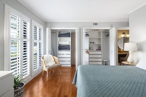 A bedroom with a bed, a chair, a desk, and a walk-in closet. - Renovated, Lakefront, Pinehurst #5, Ground Level, 2BR, 2BA, Pool, WiFi, Cable (Pinehurst)