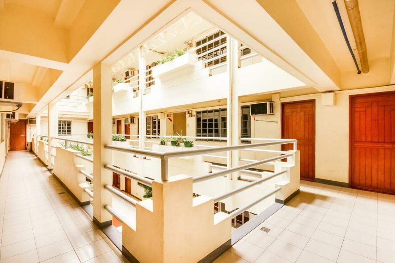 A multi-level building with a central atrium, multiple floors, and a staircase.