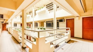 A multi-level building with a central atrium, multiple floors, and a staircase.