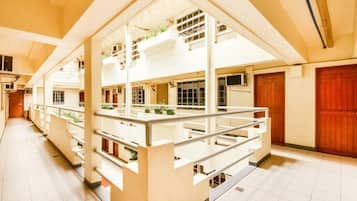 A multi-level building with a central atrium, multiple floors, and a staircase.