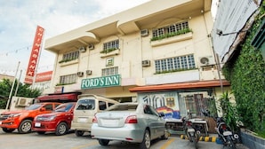 A building with a sign for 'Ford's Inn' and a 'Chinabank' sign.