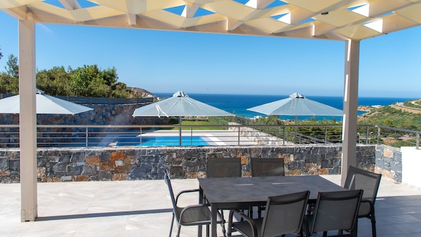 An outdoor patio with a pool, stone walls, and a view of the ocean. - Villa Marine, New Luxury Villa with Amazing Seaview & Private Pool (Bali)