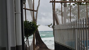 A beach view with a white fence and a tree in the foreground. - Grand Blue Beach Hotel (Boracay Island)