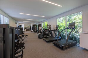 A gym with treadmills, elliptical machines, and weight equipment. - Beach Haus Bal Harbour (Bal Harbour)
