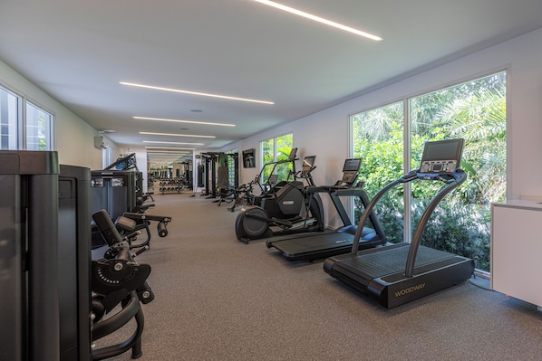 A gym with treadmills, elliptical machines, and weight equipment. - Beach Haus Bal Harbour (Bal Harbour)
