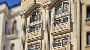 A hotel with a classic facade, multiple balconies, and a prominent entrance with a sign. - Marmara Deluxe Hotel (Istanbul)