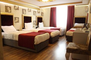 A hotel room with three beds, a desk, and a chair. - Marmara Deluxe Hotel (Istanbul)